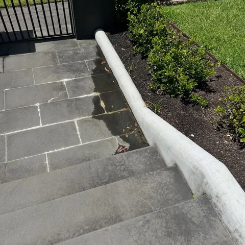 Newly installed pipe running alongside outdoor steps